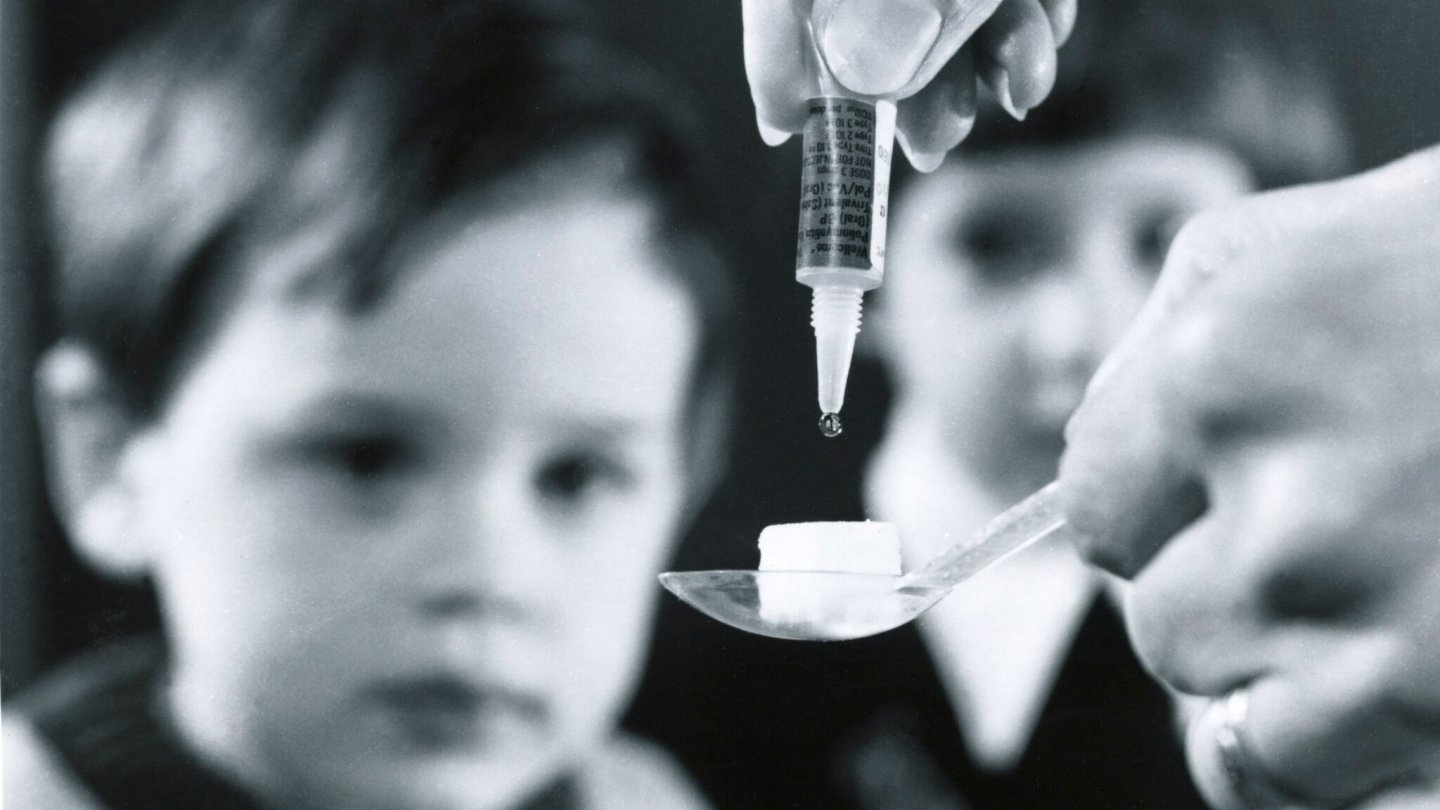 A child receives an oral vaccine.